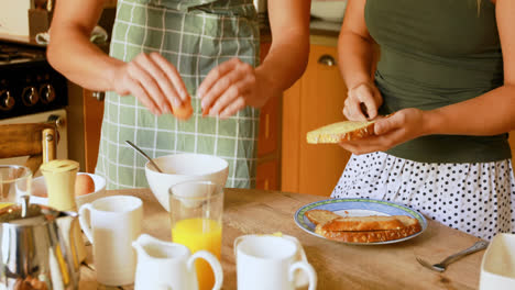 Couple-preparing-breakfast-in-kitchen-at-home-4k