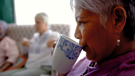 Close-up-of-active-Caucasian-senior-woman-drinking-coffee-at-nursing-home-4k