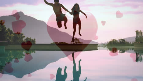 Cute-couple-jumping-in-a-lake-with-digital-hearts-on-the-background
