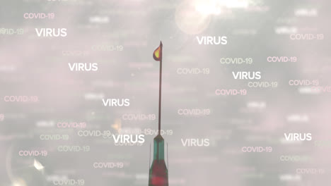 Covid-19-and-virus-text-against-close-up-of-a-syringe