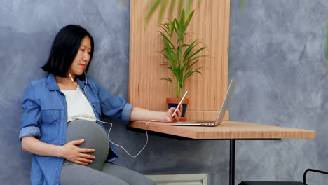 Pregnant-woman-listening-music-on-mobile-phone-4k