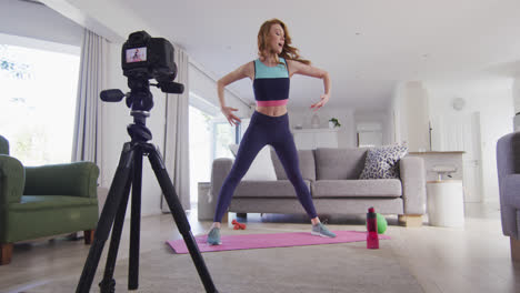 Woman-performing-exercise-at-home-and-recording-it-with-digital-camera