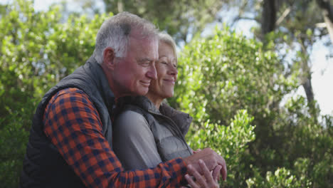 Side-view-of-active-senior-couple-in-forest