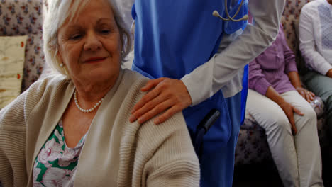 Front-view-of-active-senior-woman-holding-hand-of-female-doctor-at-nursing-home-4k