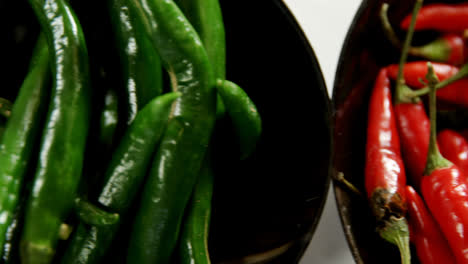 Green-and-red-chili-pepper-in-bowl-4k