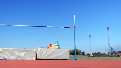 Caucasian-female-athlete-practicing-high-jump-at-sports-venue-4k