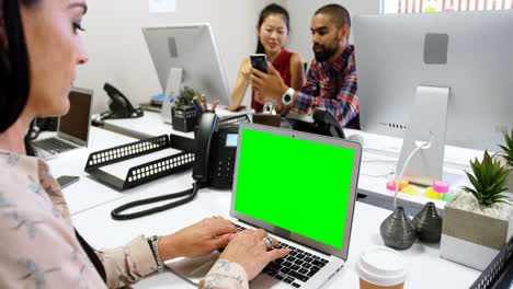 Female-executive-using-laptop-on-desk-4k