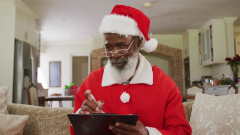 Senior-african-american-man-wearing-santa-costume-at-christmas-time