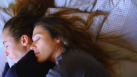 Lesbian-couple-sleeping-together-in-bedroom-4k