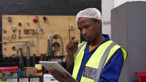 Warehouse-worker-using-a-digital-tablet