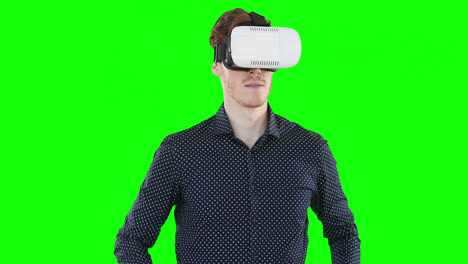 Caucasian-man-wearing-a-VR-headset-on-green-background