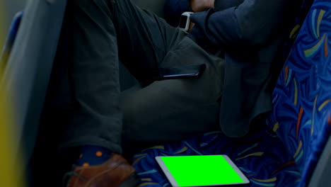 A-person-sits-on-a-bus-seat,-holding-a-smartphone,-with-copy-space