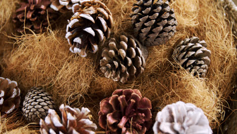 Pine-cones-and-straw-arranged-during-christmas-time-4k