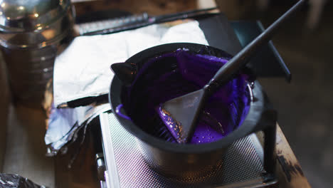 Black-bowl-full-of-purple-hair-dye-on-table-at-hair-salon
