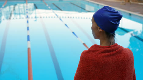 Female-swimmer-standing-near-swimming-pool-4k