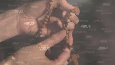 Covid-19-and-virus-text-against-hands-praying-and-holding-rosary