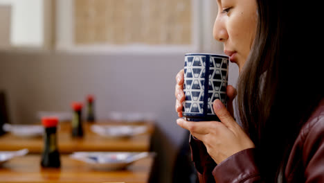 Woman-having-tea-in-restaurant-4k