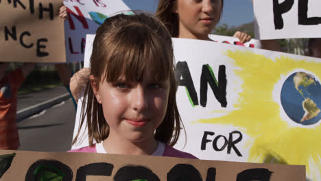 Girl-with-climate-change-sign-in-a-protest