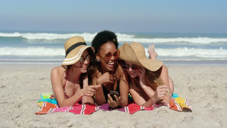 Young-female-friends-having-fun-at-beach-4k