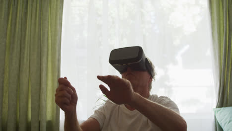 Senior-man-in-social-distancing-using-VR-headset