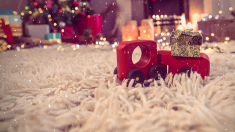 Rotes-Spielzeugauto-Auf-Einem-Teppich-In-Einem-Weihnachtlich-Dekorierten-Wohnzimmer,-Kombiniert-Mit-Fallendem-Schnee