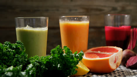 Glass-of-various-juices-and-smoothies-on-table-4k