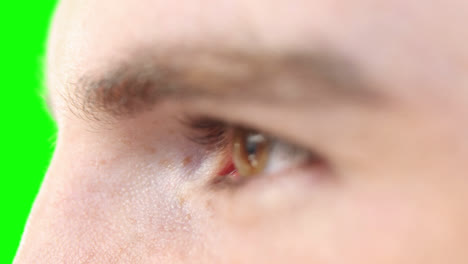 Close-up-of-a-Caucasian-man-eyes-on-green-background