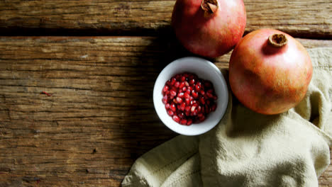 Pomegranate-and-napkin-on-wooden-table-4k
