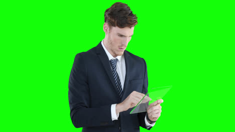 Caucasian-man-holding-a-transparent-screen-on-green-background