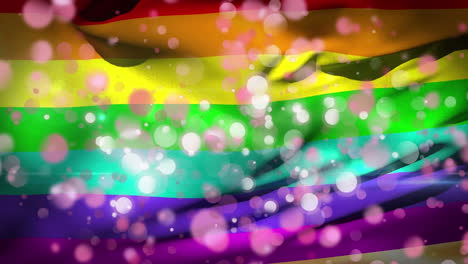 Animation-of-rainbow-flag-waving-with-white-and-pink-flickering-spots