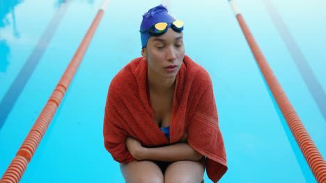 Female-swimmer-sitting-near-swimming-pool-4k