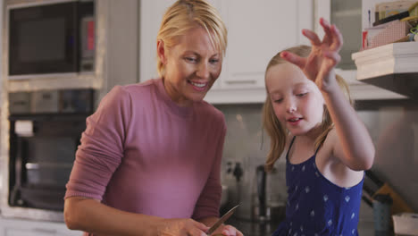 Front-view-of-Caucasian-woman-with-her-daughter-in-the-kitchen