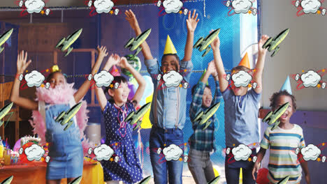 Rocket-and-cloud-icon-moving-against-kids-wearing-party-hats-dancing