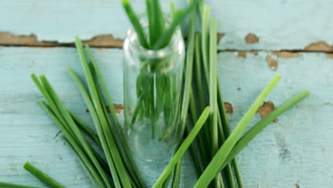 Garlic-chives-on-wooden-table-4k