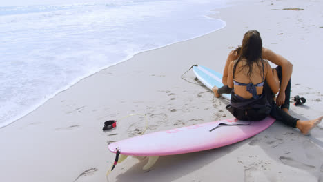 Surfer-couple-romancing-on-the-beach-4K-4k