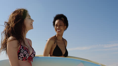 Young-female-friends-standing-with-surfboard-4k