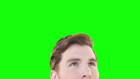 Caucasian-man-looking-up-on-green-background
