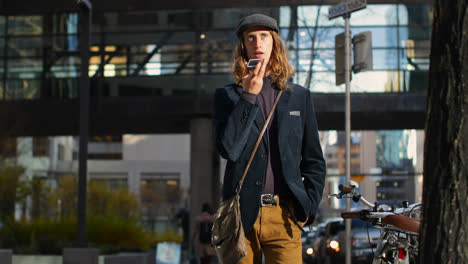 Front-view-of-young-Caucasian-man-talking-on-mobile-phone-in-the-city-4k