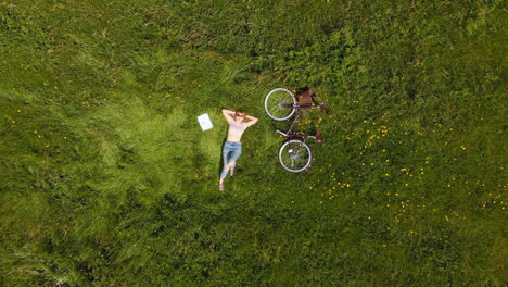 Young-woman-relaxing-in-green-field-4k