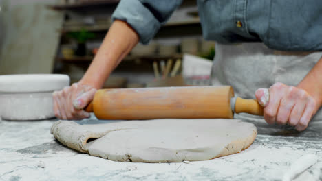 Female-potter-flattening-the-clay-with-rolling-pin-4k