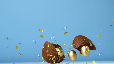 Animation-Von-Goldenem-Konfetti-über-Zerbrechenden-Schokoladen-Ostereiern,-Mit-Goldenen-Eiern-Darin,-Auf-Blauem