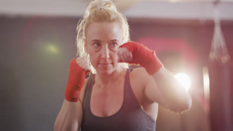 Close-up-of-caucasian-female-boxer-practicing-her-punches-at-the-gym