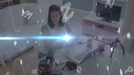 Animation-of-lights-and-floating-letters,-over-woman-using-laptop-vlogging