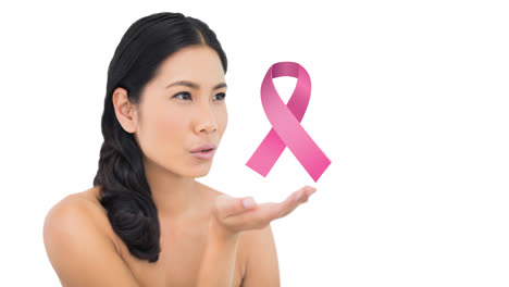 Animation-of-pink-breast-cancer-ribbon-logo-over-young-woman