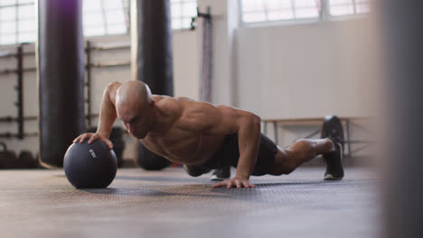Fit-caucasian-man-working-out-with-medicine-ball-at-the-gym