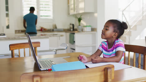 African-american-girl-drawing-during-online-school-at-home