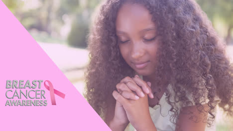 Animation-of-pink-ribbon-logo-with-hope-text-over-girl-praying