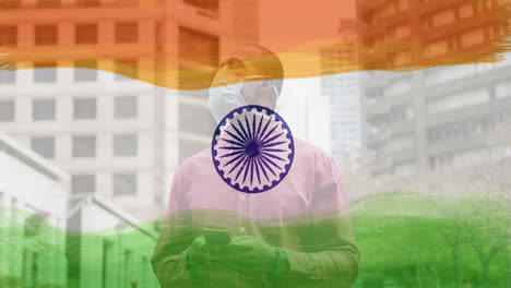 Composition-of-man-wearing-face-mask-in-street-over-indian-flag