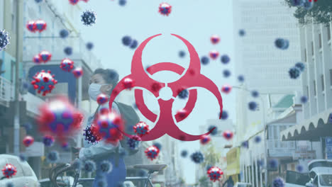 Animation-of-covid-19-virus-cells-and-biohazard-icon-over-woman-wearing-face-mask-wheeling-bike