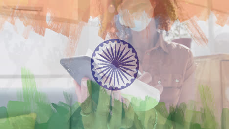 Animation-of-woman-wearing-face-mask-in-office-over-indian-flag
